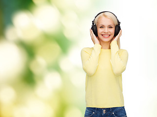 Image showing smiling young woman with headphones