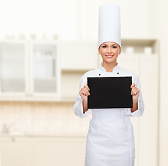 Image showing smiling female chef with black blank paper