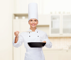 Image showing smiling female chef with pan and spoon