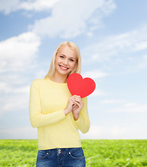 Image showing smiling woman with red heart