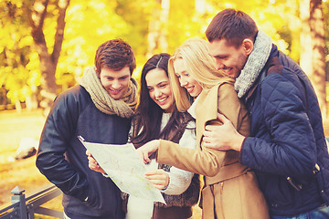 Image showing couples with tourist map in autumn park