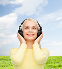 Image showing smiling young woman with headphones