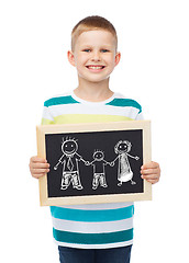 Image showing smiling little boy holding chalkboard with family