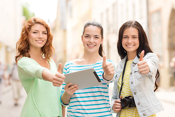 Image showing smiling teenage girls with tablet pc and camera