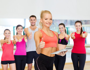 Image showing smiling sporty woman with tablet pc computer