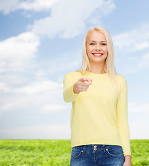 Image showing smiling woman pointing finger at you