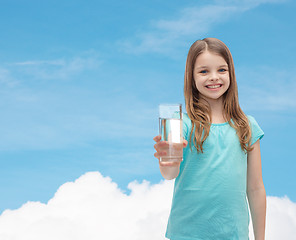 Image showing smiling little girl giving glass of water