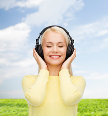 Image showing smiling young woman with headphones