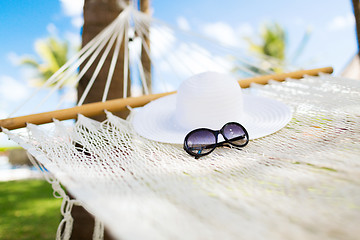 Image showing picture of hammock with white hat and sunglasses