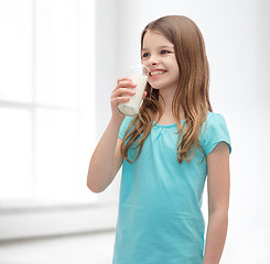 Image showing smiling little girl drinking milk out of glass