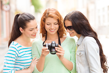 Image showing smiling teenage girls with camera