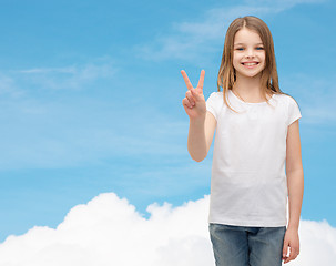 Image showing little girl in white t-shirt showing peace gesture