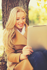 Image showing woman with tablet pc in autumn park