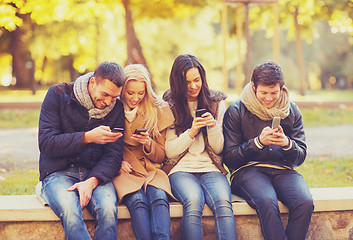 Image showing group of friends having fun in autumn park