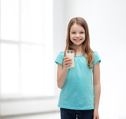 Image showing smiling little girl with glass of milk