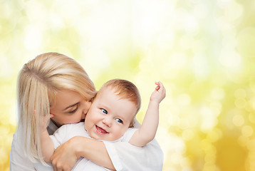 Image showing happy mother kissing smiling baby