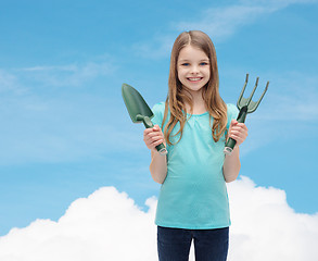 Image showing smiling little girl with rake and scoop