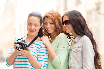 Image showing smiling teenage girls with camera