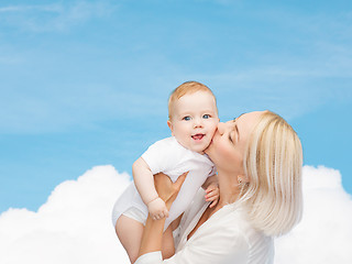 Image showing happy mother kissing smiling baby