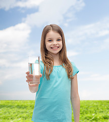 Image showing smiling little girl giving glass of water