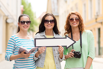 Image showing smiling teenage girls with white arrow outdoors