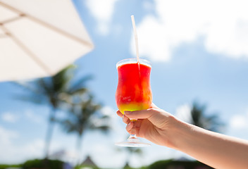 Image showing close-up of hand holding glass with cocktail