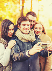 Image showing group of friends taking selfie in autumn park