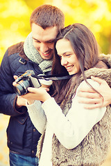 Image showing couple with photo camera in autumn park