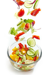 Image showing Fresh vegetables falling into the glass bowl