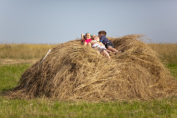 Image showing Children resting in the hay