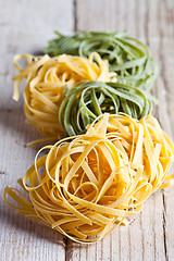 Image showing yellow and green uncooked pasta tagliatelle