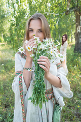 Image showing Beautiful blonde woman with bouquet of camomiles