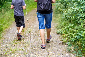 Image showing Woman walking with son cross country