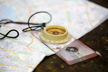 Image showing old touristic compass on map 