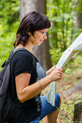 Image showing Lost woman in the countryside holding a map