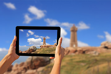 Image showing Woman taking pictures on a tablet lighthouse