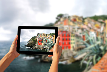 Image showing Girl taking pictures on a tablet in Riomaggiore