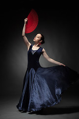 Image showing woman dancing flamenco on black