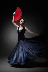 Image showing woman dancing flamenco on black