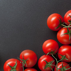 Image showing red tomatoes on blac