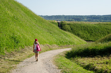 Image showing tourist woman walk mound hills 