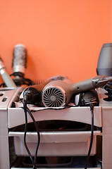 Image showing hairdressing accessories  lies in the gray shelf 