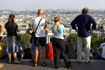 Image showing People watching sunset over paris skyline from the steps of the sacre coeur montmartre