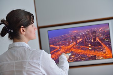 Image showing young woman watching tv at home