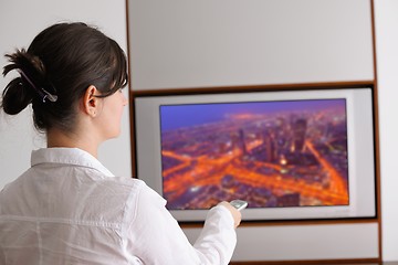 Image showing young woman watching tv at home