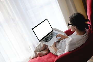 Image showing woman using a laptop computer at home