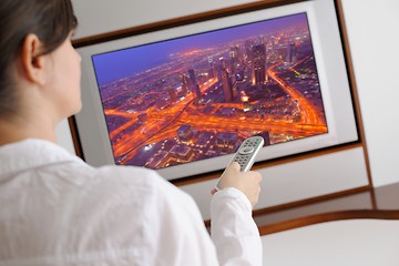 Image showing young woman watching tv at home