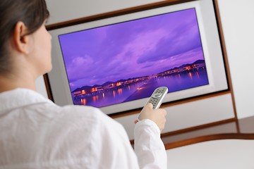 Image showing young woman watching tv at home