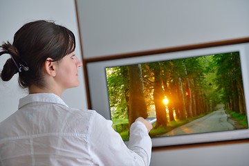 Image showing young woman watching tv at home