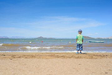 Image showing Little boy standing on the beach